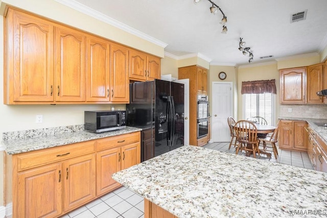 kitchen featuring stainless steel appliances, light tile patterned floors, rail lighting, decorative backsplash, and light stone counters