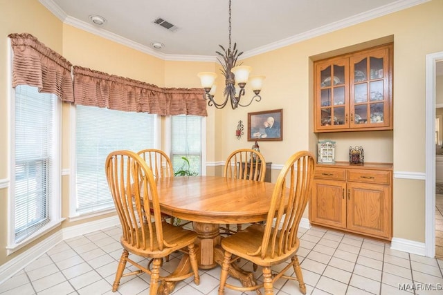 dining space featuring light tile patterned floors, crown molding, plenty of natural light, and a chandelier