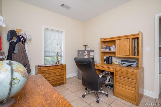 office space with light tile patterned floors and baseboards