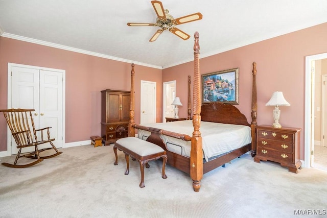 bedroom with light colored carpet, crown molding, baseboards, ensuite bath, and a ceiling fan