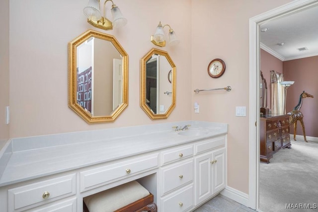 bathroom with crown molding, vanity, and baseboards