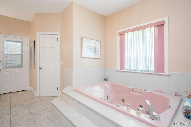 bathroom with a whirlpool tub and tile patterned flooring