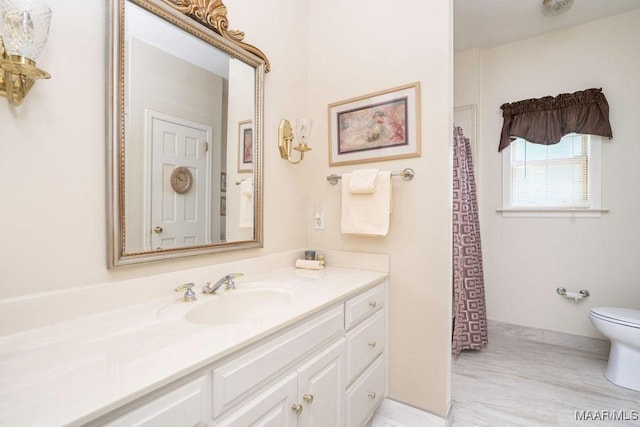bathroom featuring toilet and vanity