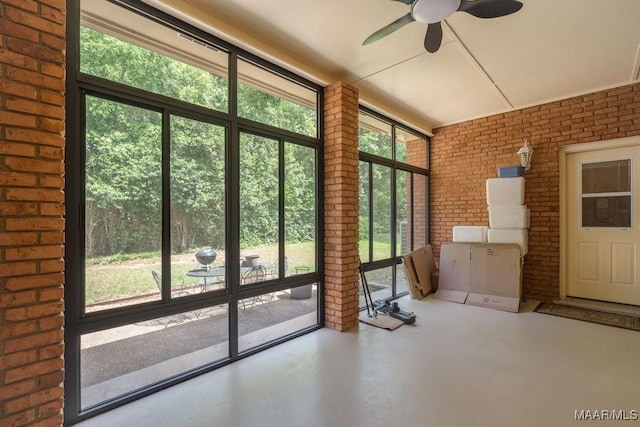 unfurnished sunroom with ceiling fan