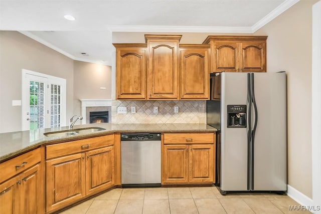 612 Coleman Way, Prattville, AL 36067 - kitchen with appliances with stainless steel finishes, a sink, ornamental molding, brown cabinets, and backsplash
