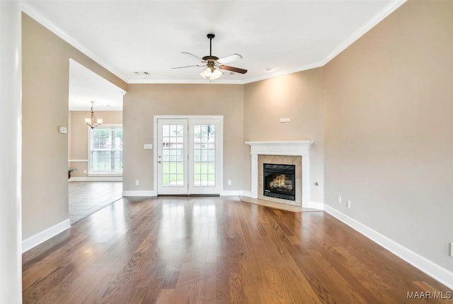 612 Coleman Way, Prattville, AL 36067 - unfurnished living room with a tiled fireplace, a ceiling fan, wood finished floors, a chandelier, and baseboards