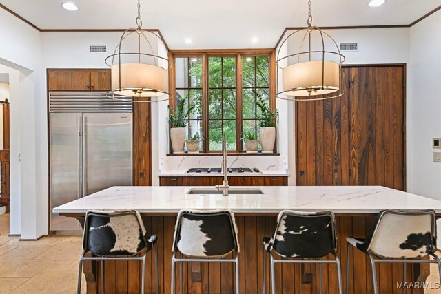 1777 Barganier Rd, Cecil, AL 36013 - kitchen featuring built in fridge, decorative light fixtures, recessed lighting, light stone countertops, and a kitchen breakfast bar
