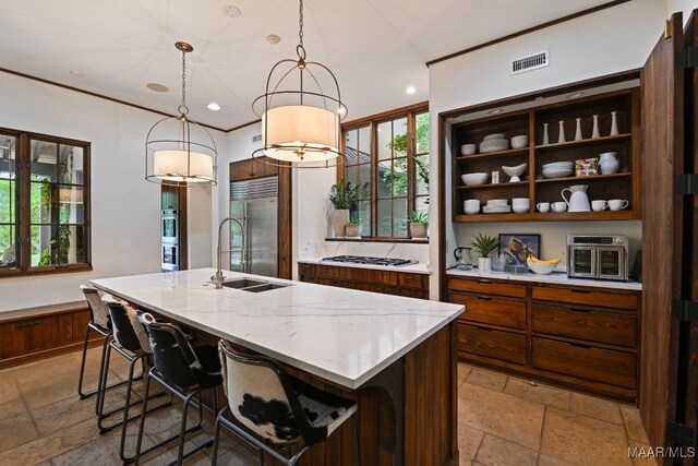 1777 Barganier Rd, Cecil, AL 36013 - kitchen featuring a sink, stone tile flooring, stainless steel built in fridge, a kitchen island with sink, and hanging light fixtures