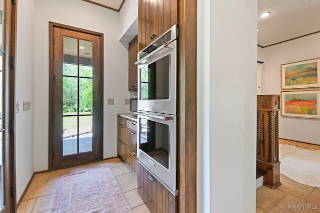 1777 Barganier Rd, Cecil, AL 36013 - kitchen with stainless steel double oven, light countertops, recessed lighting, brown cabinets, and baseboards