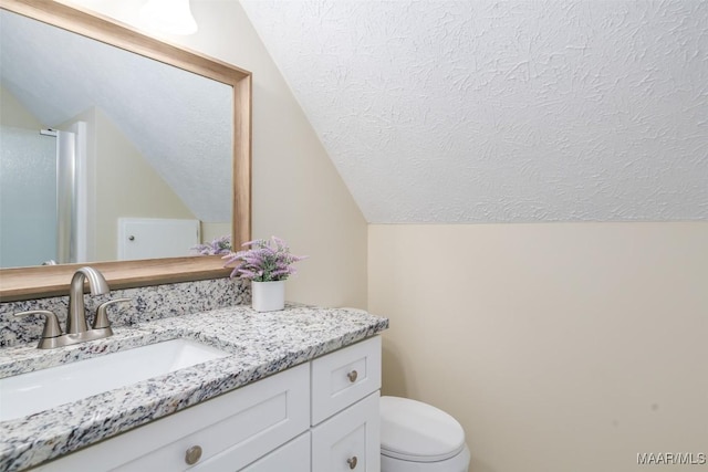 2224 Halcyon Blvd, Montgomery, AL 36117 - bathroom with vaulted ceiling, a textured ceiling, vanity, and toilet