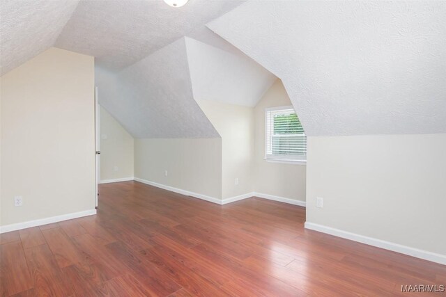 2224 Halcyon Blvd, Montgomery, AL 36117 - bonus room featuring a textured ceiling, wood finished floors, lofted ceiling, and baseboards