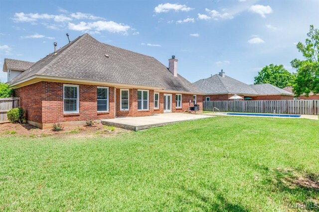 2224 Halcyon Blvd, Montgomery, AL 36117 - rear view of property featuring a chimney, a patio area, brick siding, and a shingled roof