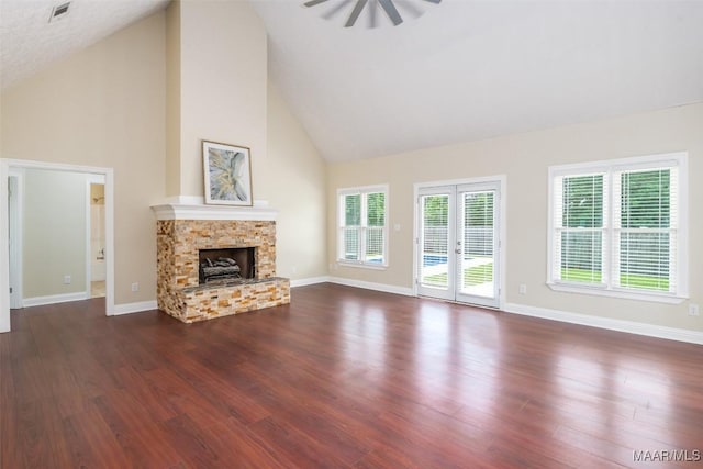2224 Halcyon Blvd, Montgomery, AL 36117 - unfurnished living room featuring high vaulted ceiling, a ceiling fan, a stone fireplace, dark wood-type flooring, and baseboards