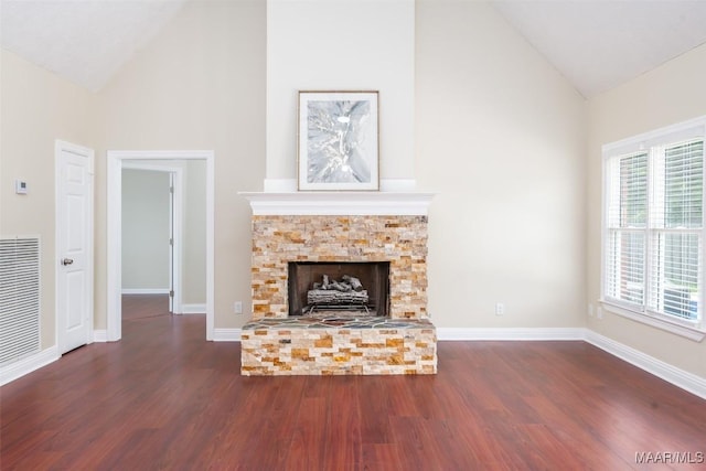 2224 Halcyon Blvd, Montgomery, AL 36117 - unfurnished living room featuring high vaulted ceiling, dark wood-type flooring, a fireplace with raised hearth, and baseboards
