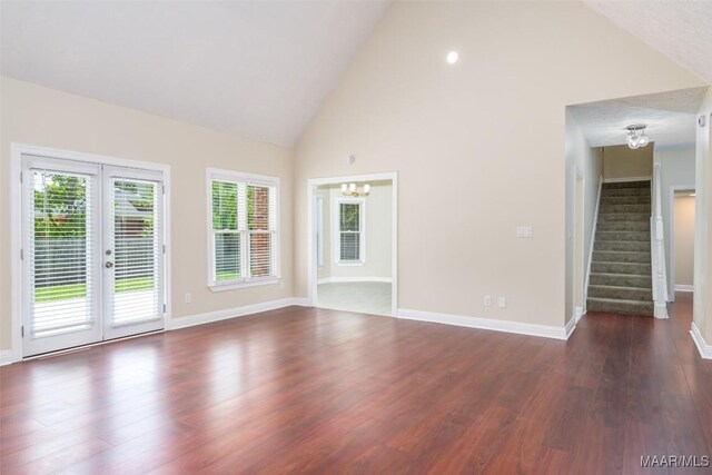 2224 Halcyon Blvd, Montgomery, AL 36117 - unfurnished living room featuring a chandelier, french doors, stairs, baseboards, and high vaulted ceiling