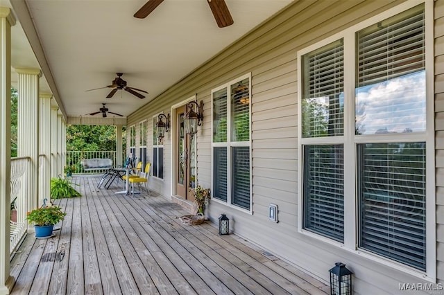 wooden terrace featuring a porch and a ceiling fan