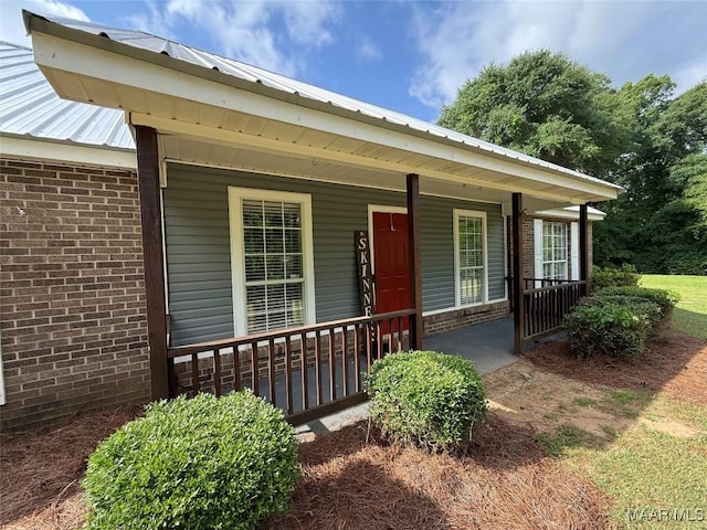 419 County Road 16, Valley Grande, AL 36701 - doorway to property with brick siding, covered porch, and metal roof