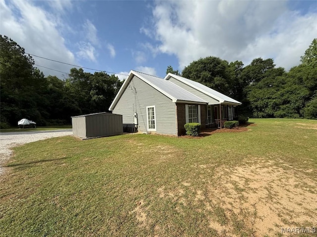 419 County Road 16, Valley Grande, AL 36701 - view of home's exterior with a yard, metal roof, cooling unit, and an outbuilding