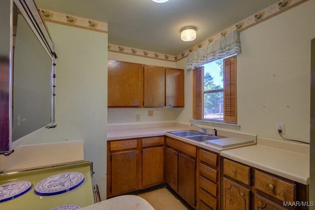 205 9th Ave, Selma, AL 36701 - kitchen featuring light countertops, brown cabinets, and a sink