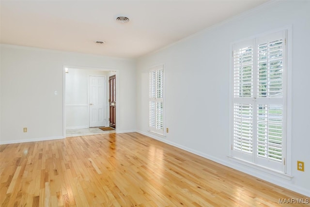 2527 Hermitage Dr, Montgomery, AL 36111 - empty room with light wood finished floors, plenty of natural light, ornamental molding, and baseboards