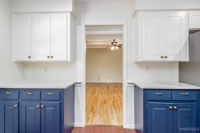 2527 Hermitage Dr, Montgomery, AL 36111 - kitchen featuring white cabinets, blue cabinetry, light countertops, ceiling fan, and baseboards
