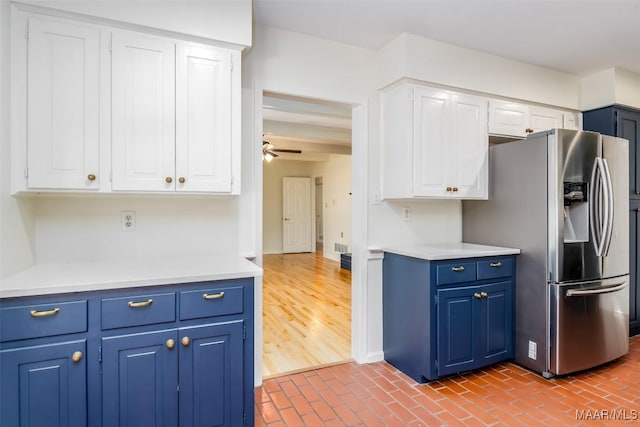 2527 Hermitage Dr, Montgomery, AL 36111 - kitchen featuring stainless steel fridge with ice dispenser, blue cabinetry, and white cabinets