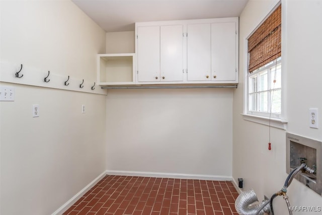 2527 Hermitage Dr, Montgomery, AL 36111 - laundry room featuring cabinet space, baseboards, brick patterned floors, and washer hookup