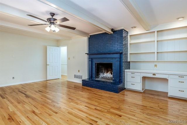 2527 Hermitage Dr, Montgomery, AL 36111 - unfurnished living room with a brick fireplace, beam ceiling, light wood-type flooring, a ceiling fan, and baseboards