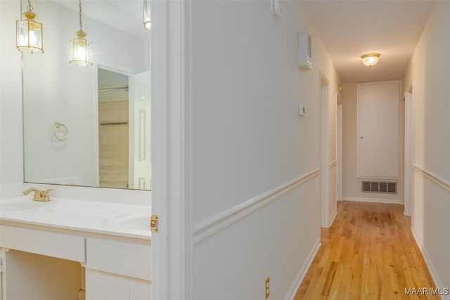 2527 Hermitage Dr, Montgomery, AL 36111 - hall with a sink, light wood-style floors, and baseboards