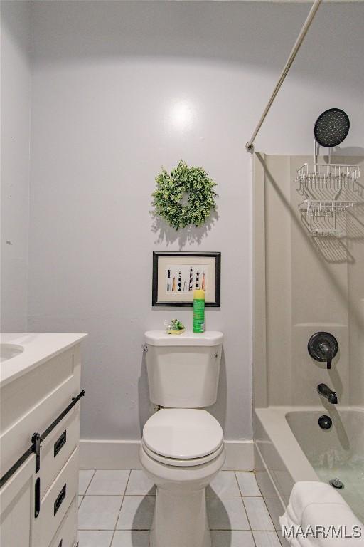 full bath featuring tile patterned flooring, baseboards, vanity, toilet, and shower / bath combination
