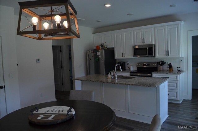 7330 Butler Mill Rd, Ramer, AL 36069 - kitchen featuring stainless steel appliances, a sink, white cabinetry, a chandelier, and tasteful backsplash