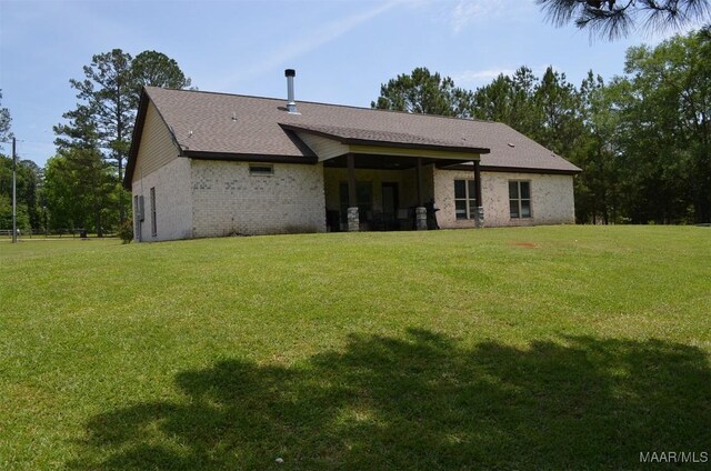 7330 Butler Mill Rd, Ramer, AL 36069 - back of house featuring a lawn, brick siding, and roof with shingles