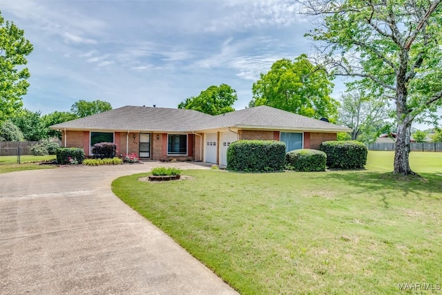 100 Duck Cv, Elmore, AL 36025 - ranch-style house with driveway, a garage, and brick siding