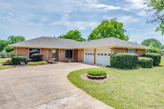 100 Duck Cv, Elmore, AL 36025 - ranch-style house featuring an attached garage, brick siding, concrete driveway, a front lawn, and roof with shingles
