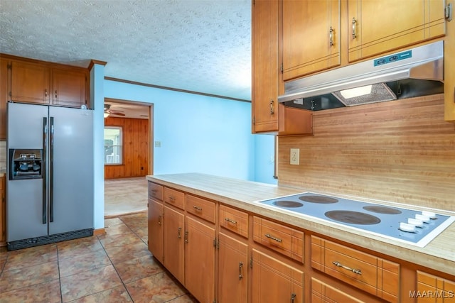 100 Duck Cv, Elmore, AL 36025 - kitchen with refrigerator with ice dispenser, under cabinet range hood, white electric cooktop, light countertops, and wood walls