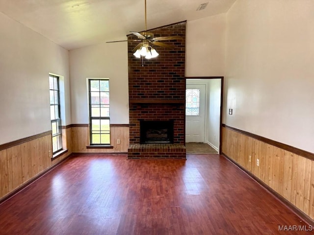 544 Sheila Blvd, Prattville, AL 36066 - unfurnished living room with vaulted ceiling, a wainscoted wall, wood finished floors, healthy amount of natural light, and wooden walls
