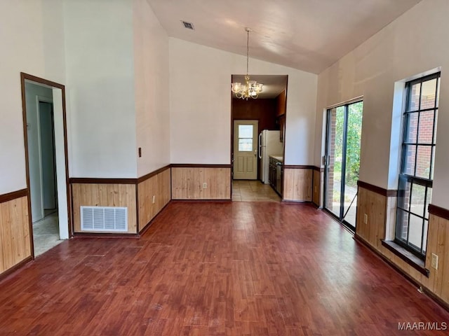 544 Sheila Blvd, Prattville, AL 36066 - empty room featuring dark wood-type flooring, a chandelier, high vaulted ceiling, a wainscoted wall, and wooden walls