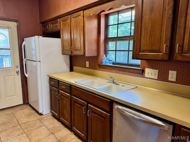 544 Sheila Blvd, Prattville, AL 36066 - kitchen with stainless steel dishwasher, a sink, light countertops, wallpapered walls, and freestanding refrigerator