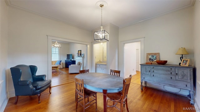 356 Cloverdale Rd, Montgomery, AL 36104 - dining room with a chandelier, wood finished floors, crown molding, and baseboards