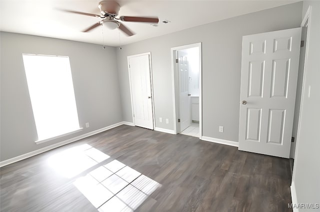 445 Durden Rd, Prattville, AL 36067 - unfurnished bedroom featuring dark wood-type flooring, baseboards, a ceiling fan, and connected bathroom