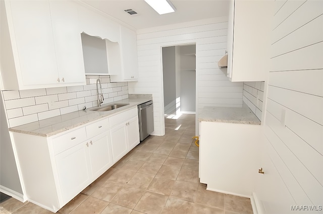 445 Durden Rd, Prattville, AL 36067 - kitchen with a sink, stainless steel dishwasher, tasteful backsplash, light tile patterned floors, and white cabinets