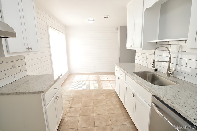 445 Durden Rd, Prattville, AL 36067 - kitchen with stainless steel dishwasher, decorative backsplash, light tile patterned floors, white cabinetry, and a sink