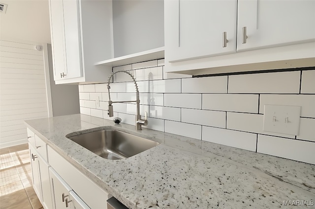 445 Durden Rd, Prattville, AL 36067 - kitchen featuring a sink, white cabinets, backsplash, open shelves, and light stone counters