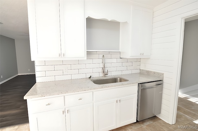 445 Durden Rd, Prattville, AL 36067 - kitchen featuring stainless steel dishwasher, a sink, white cabinets, light stone countertops, and baseboards