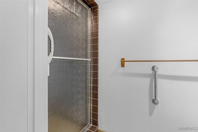 bathroom with a tile shower