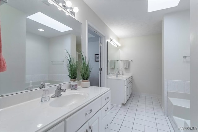 847 Dee Dr, Prattville, AL 36066 - bathroom with a skylight, tile patterned flooring, two vanities, and a bath