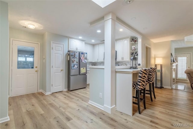 847 Dee Dr, Prattville, AL 36066 - kitchen with freestanding refrigerator, white cabinets, light wood-style floors, and recessed lighting