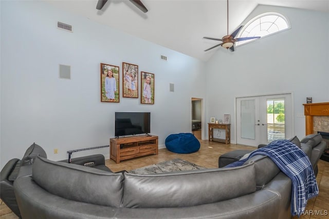 living area featuring ceiling fan, high vaulted ceiling, and baseboards