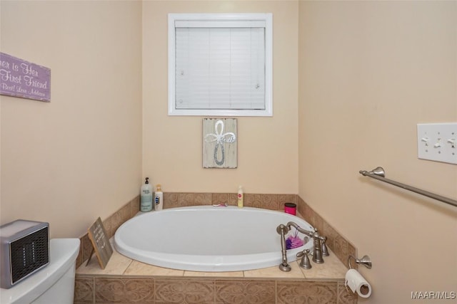full bathroom featuring a bath and toilet