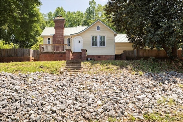 ranch-style house with fence, a chimney, metal roof, and crawl space